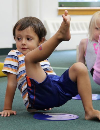 Two children doing a gymnastics exercise at the Columbus Gym in New York.