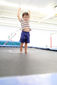 A young boy enjoying a trampoline at an indoor gym during birthday parties.